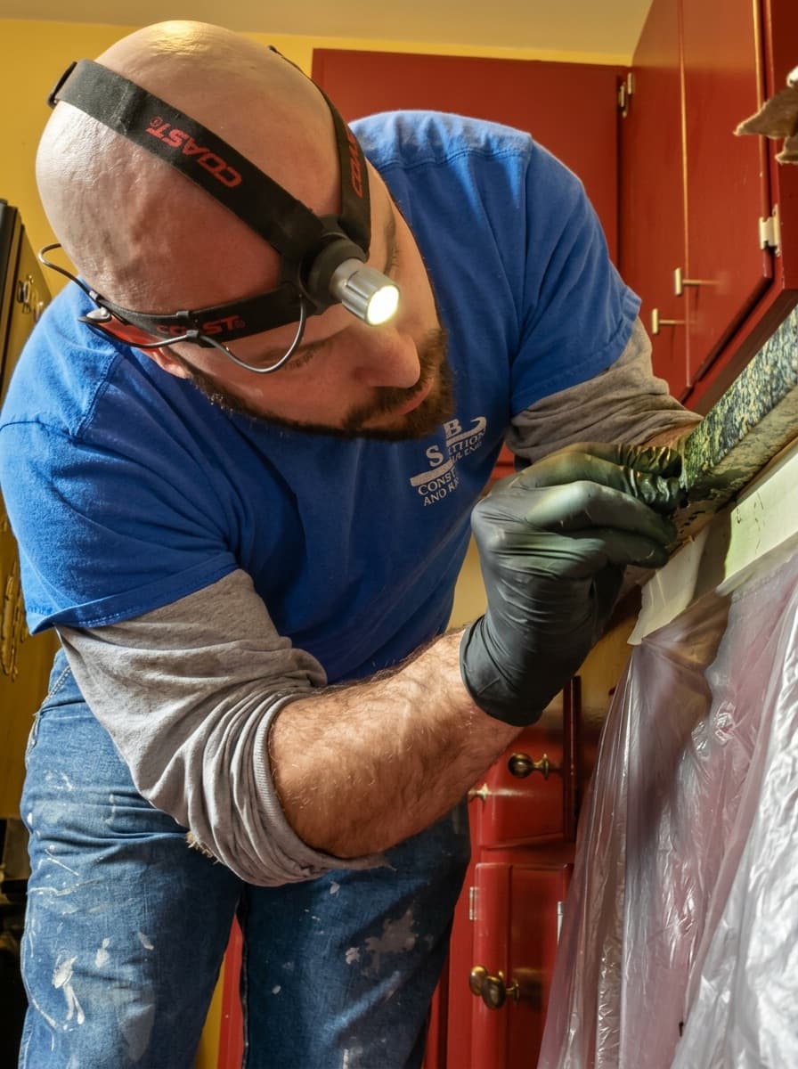 About Us: Brian Myers completing trim detail work during a remodel