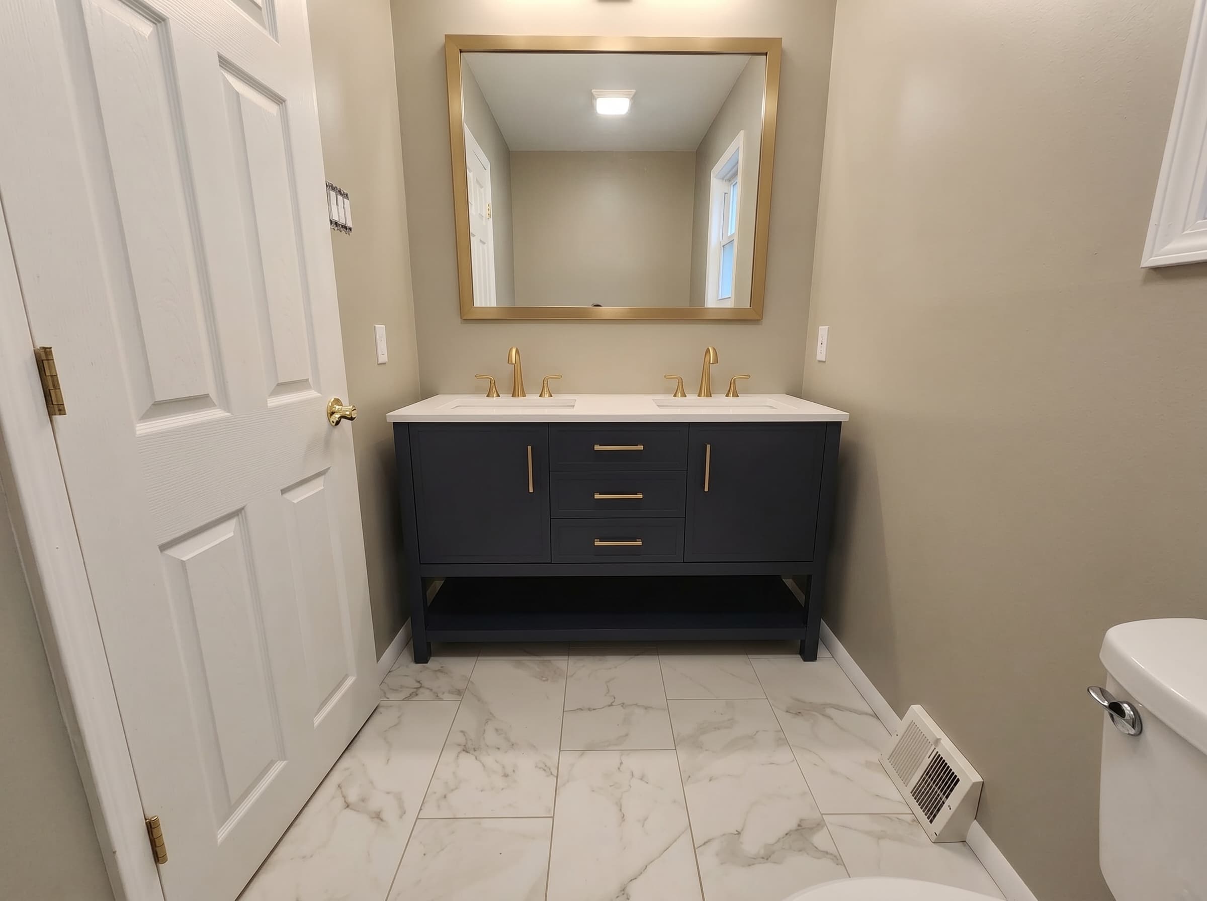 Finished Warrington bathroom with double vanity and brass fixtures